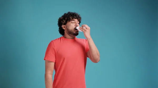 Indian Young Man Sneezes Coughs Wipes Himself Tissue Blue Studio — Stock Photo, Image