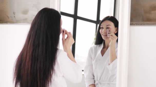Wanita Berambut Cokelat Membuat Pijat Wajah Dengan Scraper Gouache Cermin — Stok Video