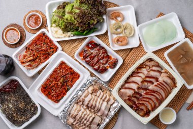 Korean food, pork feet, boiled pork, bossam, garlic, red pepper, lettuce, ssamjang, makguksu, dumpling clipart