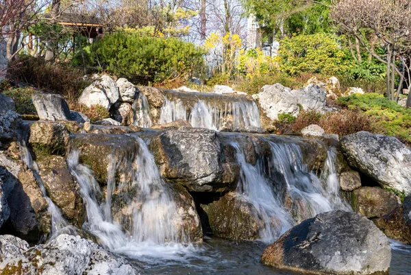 Little waterfall in Setagaya park, Vienna. View of waterfall in beautiful garden at springtime.