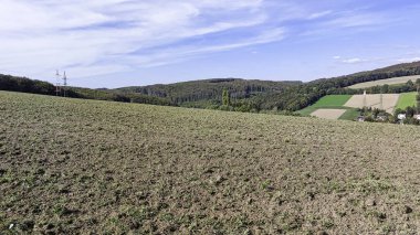 Çiftlik alanı ve bulutlu mavi gökyüzü. Yaz posteri için sade bir manzara. Tatil için en iyi manzara.