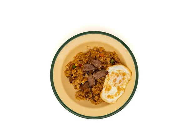 stock image Homemade fried rice with sliced grilled lamb and fried egg on a tin plate, isolated on white background. Top view or flat lay.