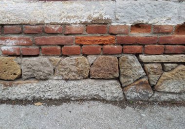 The foundation of an old house. Stones and bricks clipart