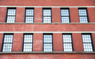 windows of an old brick wall.