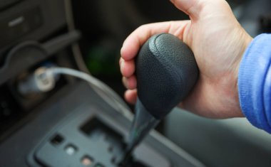 Adamın eli arabanın direksiyonunu tutarken yaklaş.