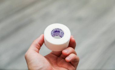 Beyaz arka planda bir el yumurtayı tutar..