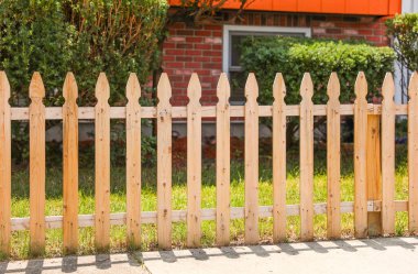 Yeşil çimlerin üzerinde ahşap bir çit