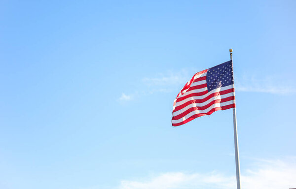 the american flag on blue sky background