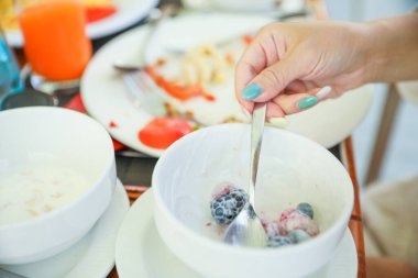 Bir kase taze meyve ve böğürtlenli kadın..