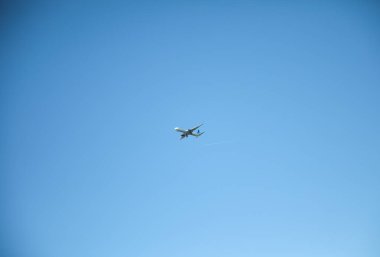 Arka planda açık gökyüzü ile uçan uçak