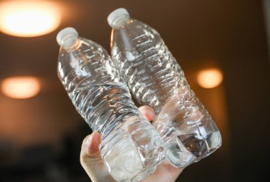 Şeffaf su bardağını tutan..