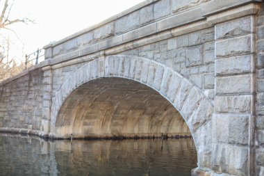 Su üzerinde taş bir köprünün güzel bir görüntüsü.