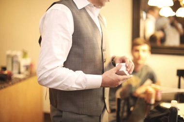 Beyaz gömlekli, kravatlı, sakallı ve soyunma odasında beyaz gömlekli bir adam.