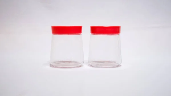 stock image This Clear Jar with Red Lid is a perfect combination of style and function. The crystal clear glass allows you to see the contents inside, while the bold red lid adds a pop of color to your storage solution.