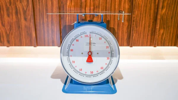 This particular weight scale has a capacity of up to 100 kilograms and is colored in blue, making it easy to identify.