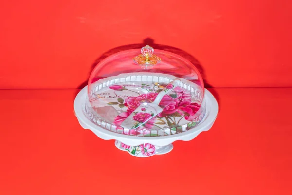 stock image The White Ceramic Round Cake Stand with Flower Motif is a stunning centerpiece for your desserts.