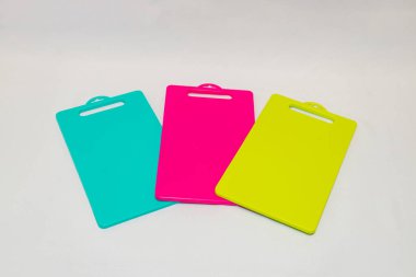 Mavi, Sarı ve Pembe Plastik Kesme Tahtası bir dizi canlı ve pratik mutfak gereksinimleridir..