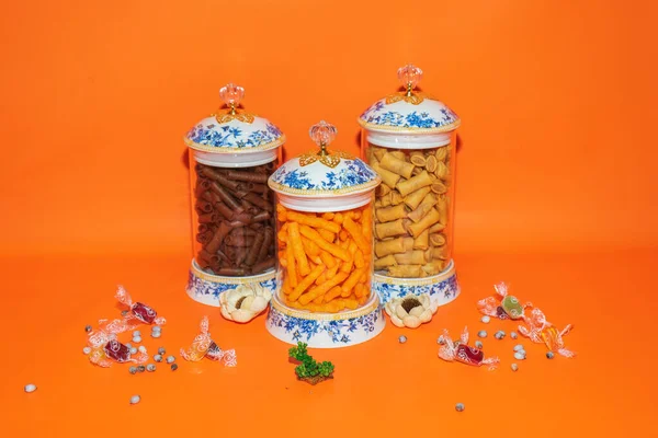 stock image The Set of Three Glass Jars with Blue Flower Pattern White Lids offers a perfect storage solution for your kitchen or pantry.