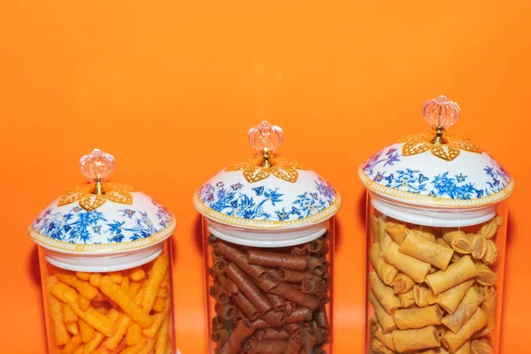 stock image The Set of Three Glass Jars with Blue Flower Pattern White Lids offers a perfect storage solution for your kitchen or pantry.