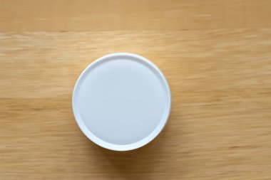 Tahta masaya boş yuvarlak bir tabak..