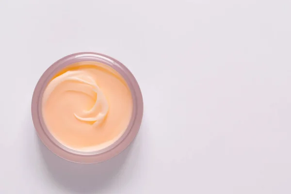cosmetic cream on a colored background.