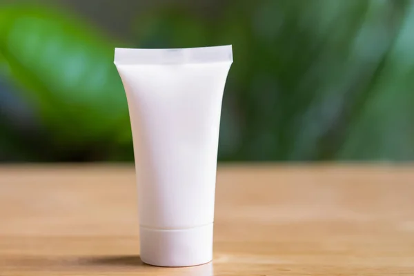 blank tube of cream on the wooden background