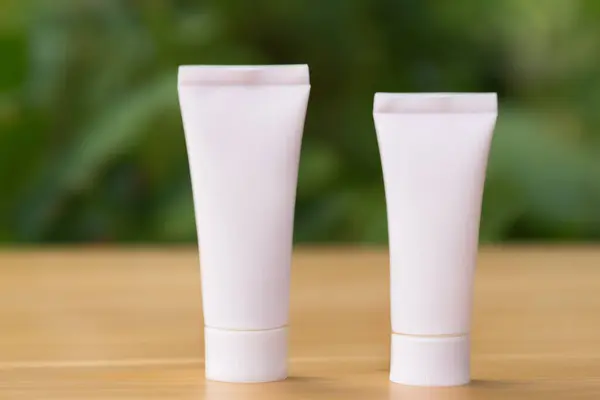 tube of cosmetic cream on wooden table