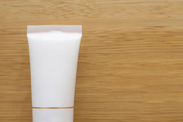 cosmetic cream tube on the wooden background. natural cosmetics, skin care, body cream.