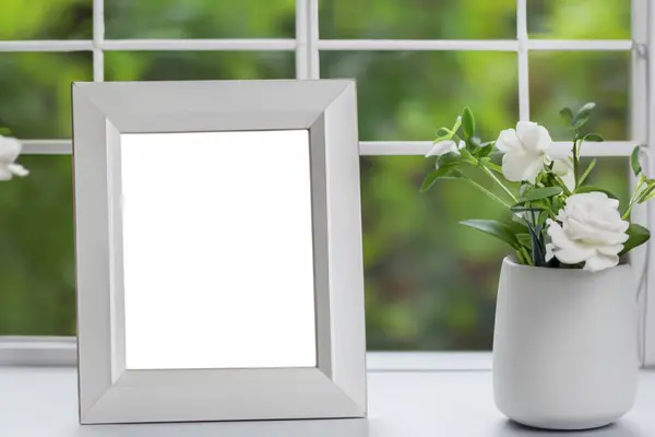 mock up frame with flowers on table