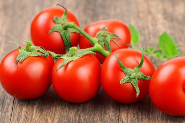 Tahta masada olgun kırmızı domatesler, yakın plan.