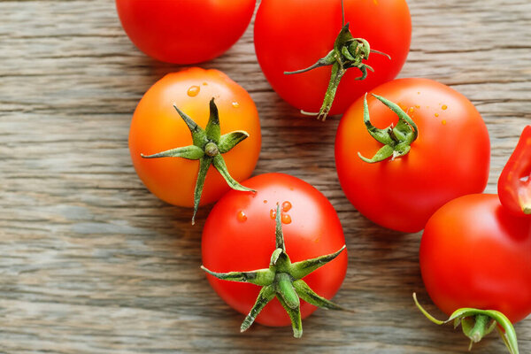 red tomatoes on a wooden background