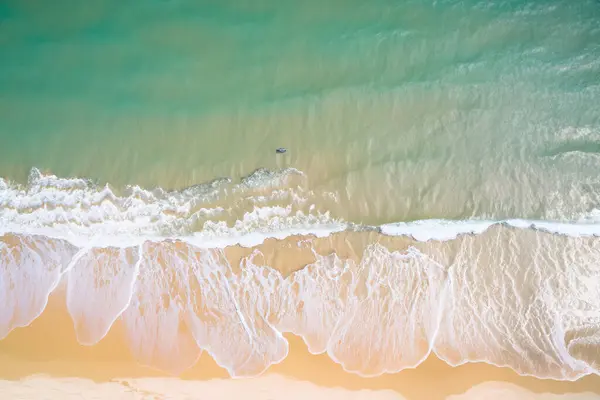 aerial view from the top of the ocean with waves.