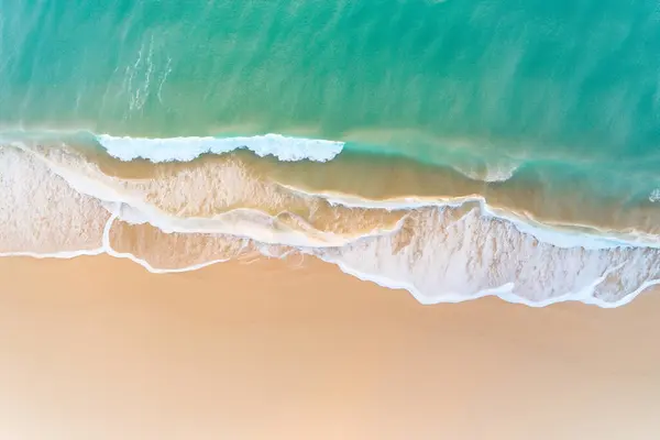 aerial view from the top of the ocean with waves.