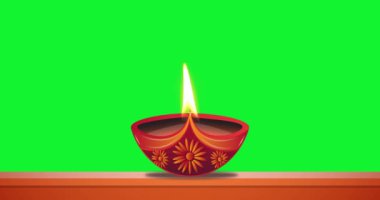 Yağ lambası yeşil ekran arka planda yanıyor. Diwali kutlaması, ışık festivali. Mutlu bayramlar.
