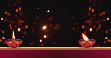 Havai fişek patlaması Diwali festivali kutlamaları sırasında siyah arka plan ve duvarda yanan gaz lambası üzerinde bokeh etkisi yarattı.