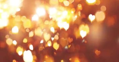 Siyah arka plan üzerinde bokeh etkisi olan parlayan bir kalp. Romantik Soyut Hareket Arkaplanı. Sevgililer Günü, Festival, Düğün, Noel, Diwali, Kutlama, Yeni Yıl.