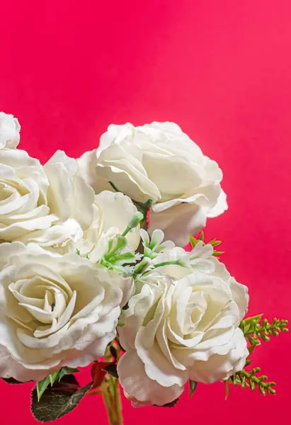 White rose bouquet on a red background with copy space for your text