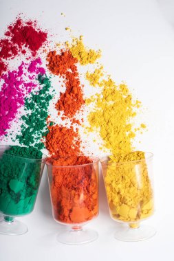 Beyaz arka planda plastik kaplarda renkli holi tozu. en üstteki görünüm