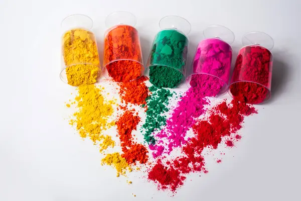 stock image Colorful holi powder in a plastic containers on white background.