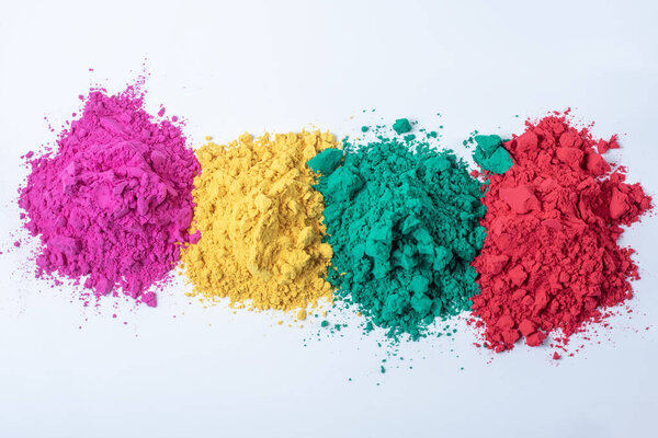 Pile of multicolored holi powder isolated on white background. Top view.