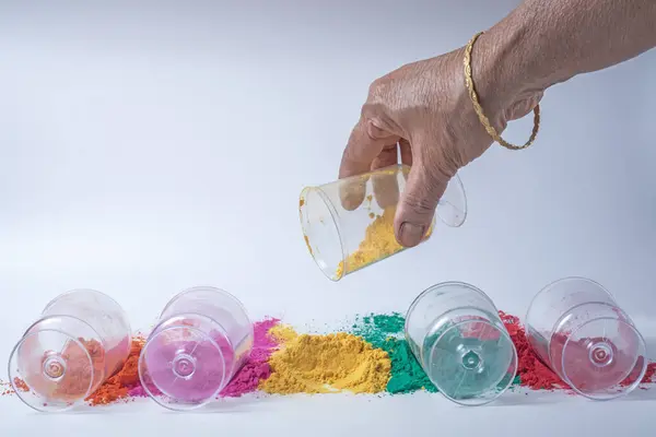 印度女人的手把黄色的胡椒粉倒进玻璃瓶里 印地安人节背景 免版税图库照片