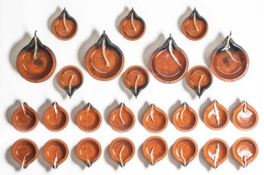 Traditional clay diyas are arranged for Diwali festival celebration. Top view clipart