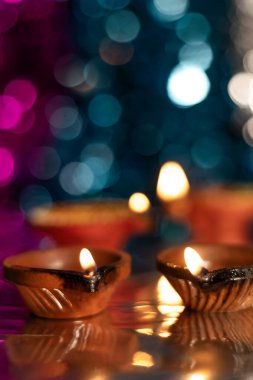 Close-up of decorated diyas during Diwali on bokeh background. Selective focus. clipart