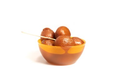 Geleneksel Hint tatlısı Gulab Jamun sarı bir kasede servis edilir festival ve şenlik için mükemmeldir..