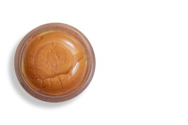 A freshly baked round butter bun enclosed in clear plastic packaging, displayed on a white background. perfect for bakery promotions, and food advertising. clipart