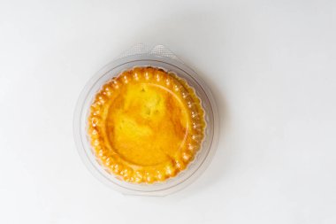 A freshly baked round butter bun enclosed in clear plastic packaging, displayed on a white background. perfect for bakery promotions, and food advertising. clipart