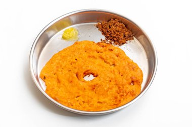 A traditional Indian dish with crispy dosa, served on a plate with country sugar and ghee.