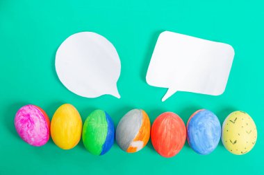Canlı el çizimleri, renkli arka planda iki boş konuşma baloncuğu olan Paskalya yumurtaları. Bayram tebrikleri, yaratıcı tasarımlar veya şenlikli mesajlar için mükemmel..