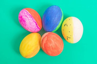 Parlak boyanmış Paskalya yumurtaları eşsiz bir şekilde canlı arka planda düzenlenmiştir. Tatil temaları ve bahar kutlamaları için mükemmeldir..