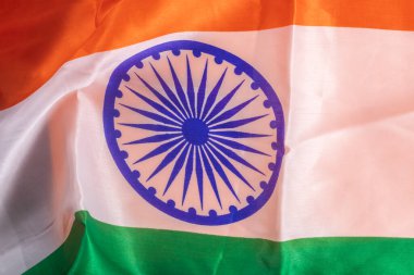 Hindistan bayrağının ortasında Ashoka çakrası işlenmiş canlı safran, beyaz ve yeşil çizgiler var..